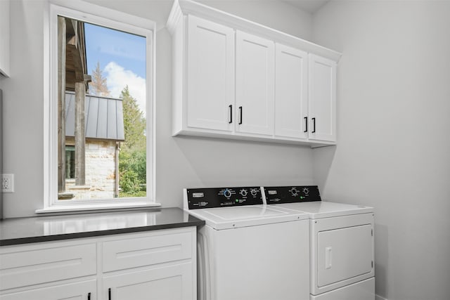 clothes washing area featuring cabinets, independent washer and dryer, and plenty of natural light