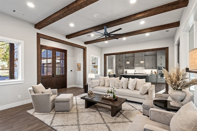 living room with beam ceiling, ceiling fan, and hardwood / wood-style flooring