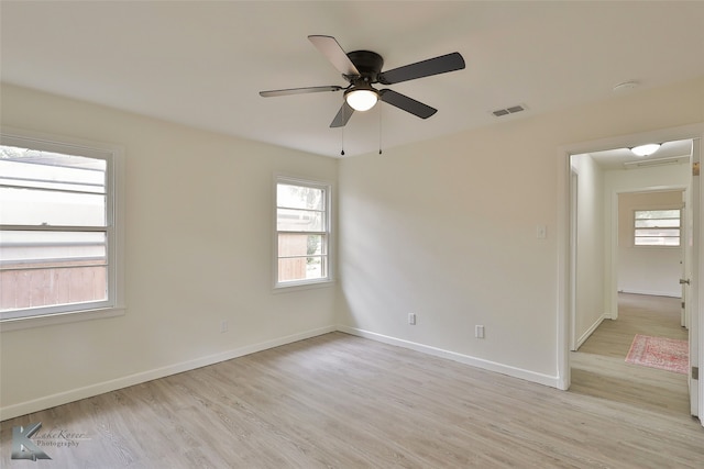 empty room with light hardwood / wood-style flooring and ceiling fan