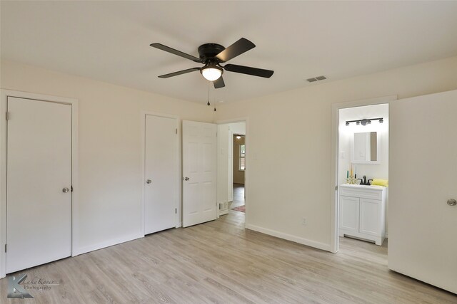 unfurnished bedroom with connected bathroom, sink, ceiling fan, and light hardwood / wood-style floors