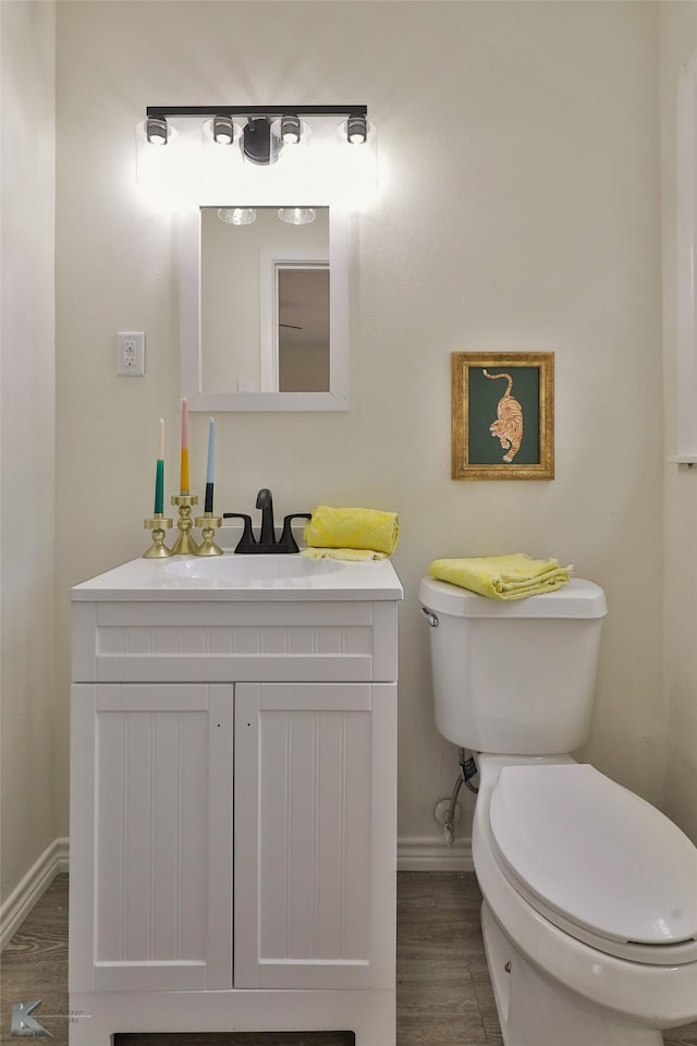 bathroom featuring vanity, toilet, and wood-type flooring