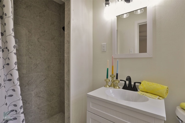 bathroom with vanity, toilet, and curtained shower