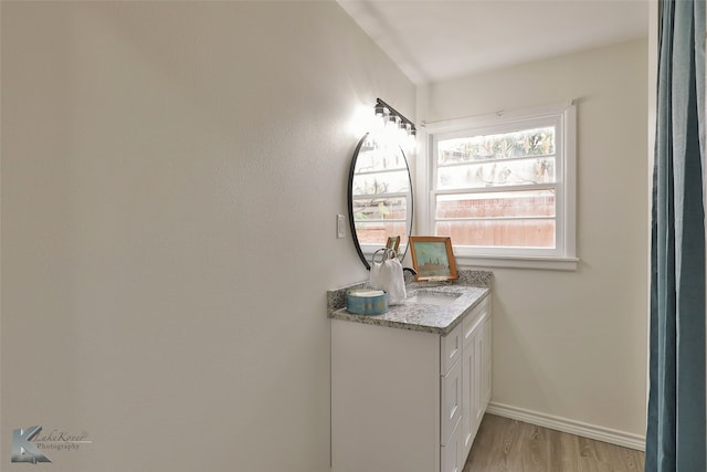 bathroom featuring vanity and hardwood / wood-style floors