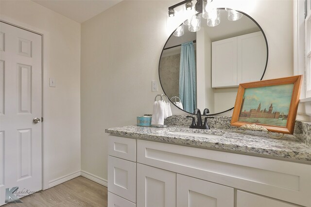 bathroom with vanity and hardwood / wood-style flooring