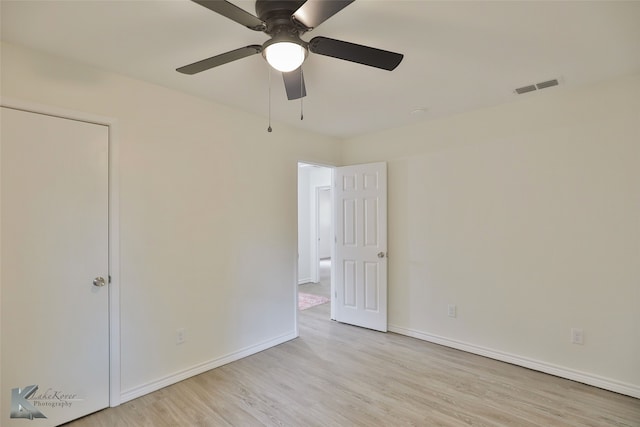 empty room featuring ceiling fan and light hardwood / wood-style flooring