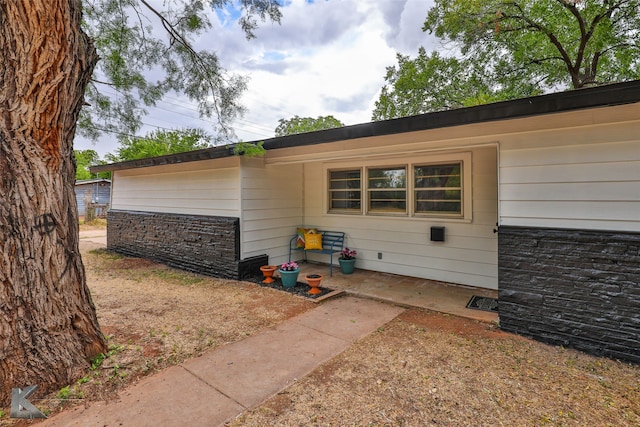 exterior space featuring stone siding