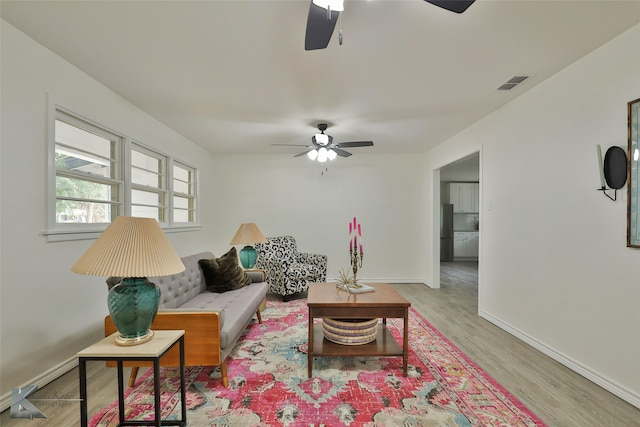 living room with ceiling fan and light hardwood / wood-style floors