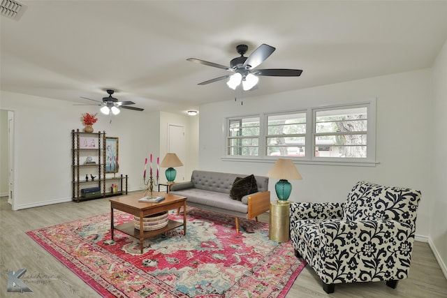 living room with ceiling fan and light hardwood / wood-style floors