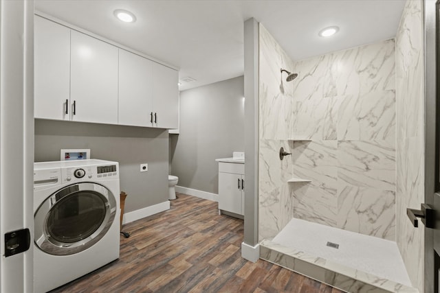 clothes washing area featuring washer / dryer and dark hardwood / wood-style floors