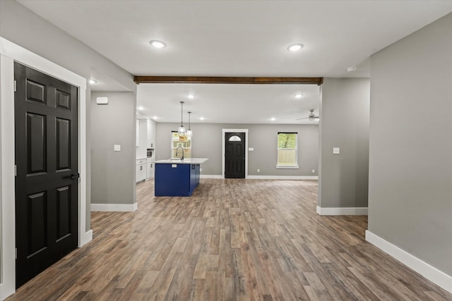 unfurnished living room with ceiling fan and dark hardwood / wood-style flooring