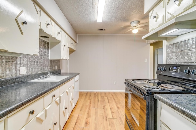 kitchen with visible vents, white dishwasher, light wood-type flooring, under cabinet range hood, and black range with electric cooktop