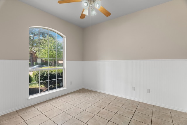 spare room featuring ceiling fan and light tile patterned flooring