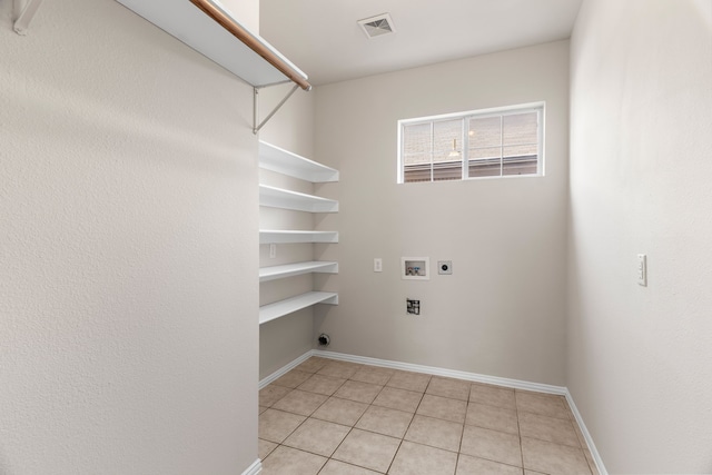 washroom with light tile patterned floors, washer hookup, and electric dryer hookup