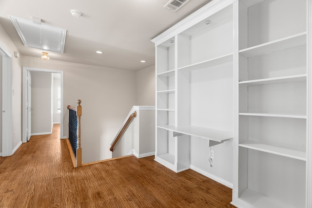 hallway with hardwood / wood-style flooring