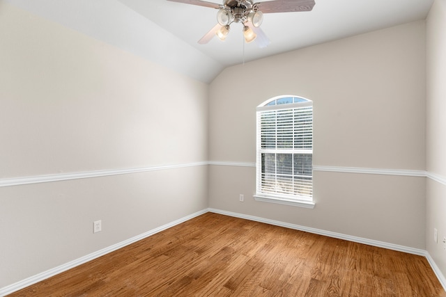 unfurnished room with lofted ceiling, ceiling fan, and wood-type flooring