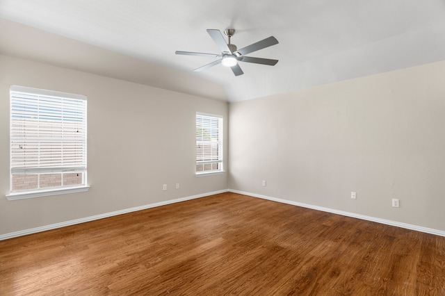 spare room with lofted ceiling, ceiling fan, and hardwood / wood-style flooring