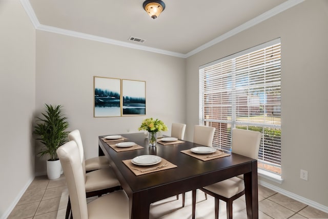 tiled dining area featuring crown molding