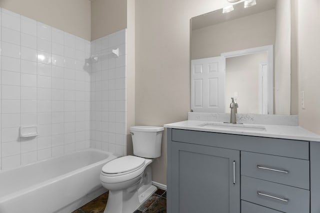 full bathroom with tile patterned flooring, toilet, tiled shower / bath combo, and vanity