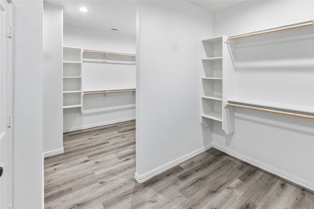 spacious closet featuring hardwood / wood-style floors