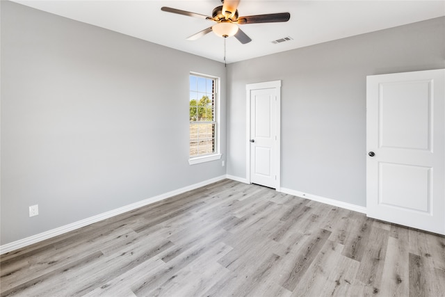 empty room with light hardwood / wood-style flooring and ceiling fan