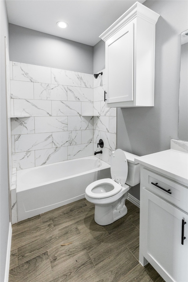 full bathroom with tiled shower / bath combo, vanity, toilet, and hardwood / wood-style flooring