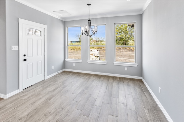 unfurnished dining area featuring plenty of natural light, a chandelier, crown molding, and light hardwood / wood-style flooring