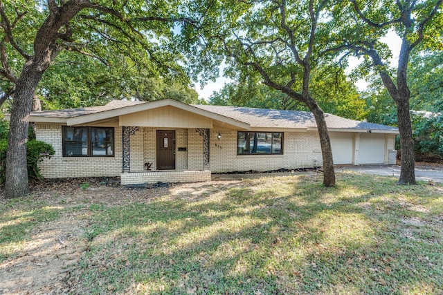 ranch-style home with a garage and a front lawn