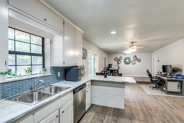 kitchen with light hardwood / wood-style flooring, white cabinets, dishwasher, and kitchen peninsula