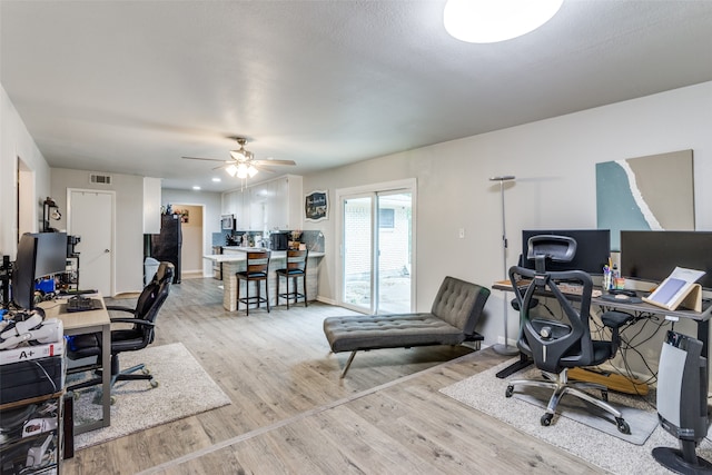 office space featuring ceiling fan and light hardwood / wood-style floors