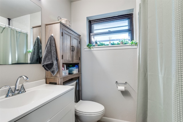 bathroom featuring vanity, toilet, and a shower with curtain