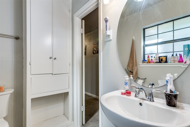 bathroom featuring toilet and sink