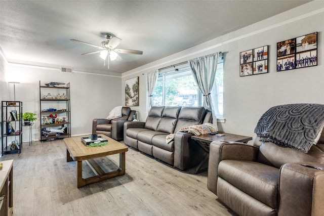 living room featuring ceiling fan and light hardwood / wood-style flooring