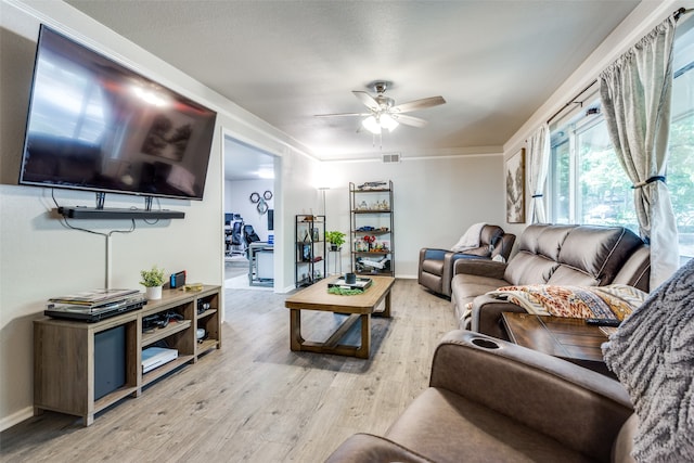 living room with ceiling fan and light hardwood / wood-style flooring