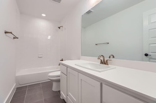 full bathroom featuring vanity, tiled shower / bath, tile patterned floors, and toilet