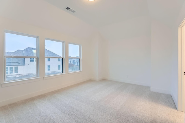 unfurnished room featuring a wealth of natural light and carpet