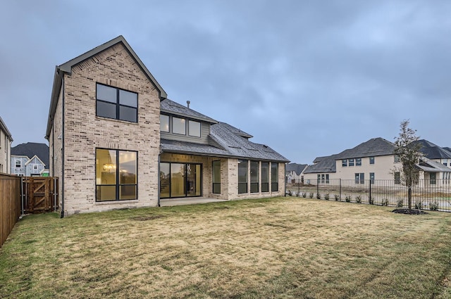 rear view of house with a lawn