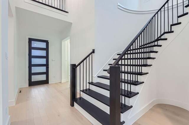 foyer featuring light hardwood / wood-style flooring and a high ceiling