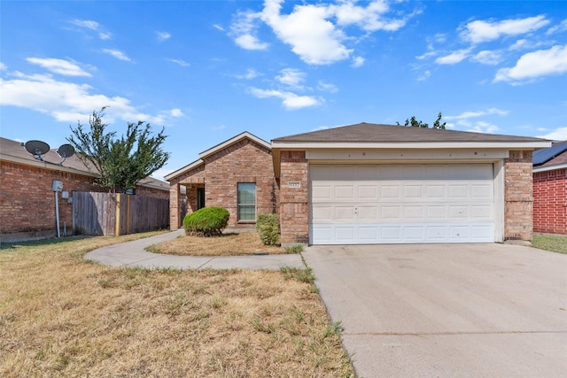 single story home featuring a garage and a front lawn