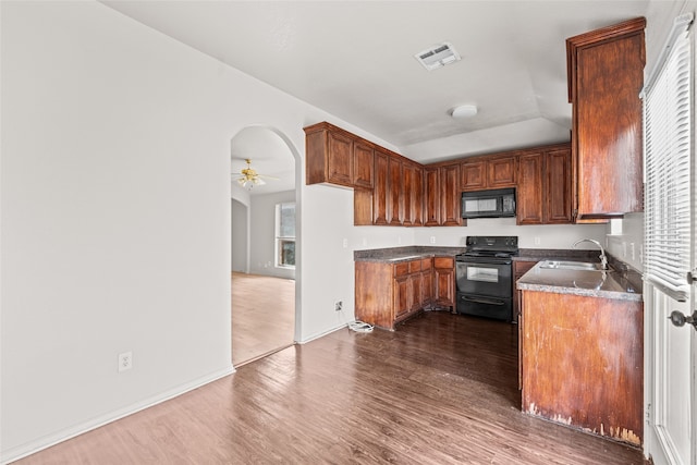 kitchen featuring black appliances, ceiling fan, sink, and dark wood-type flooring