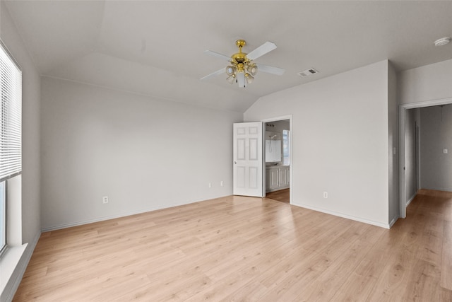 unfurnished bedroom featuring light wood-type flooring, ceiling fan, lofted ceiling, and ensuite bathroom