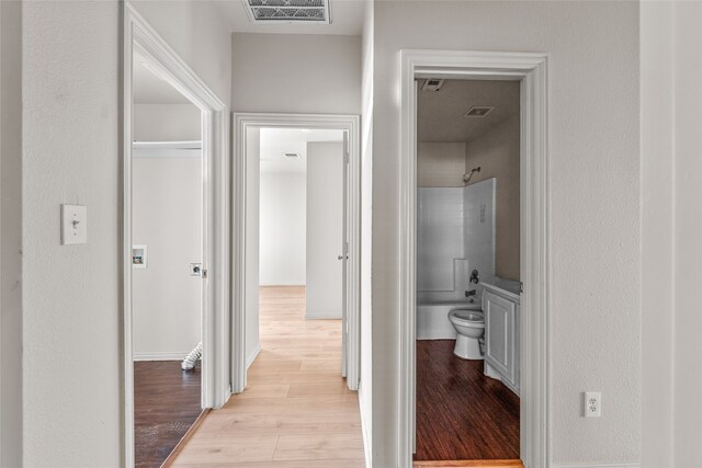 full bathroom featuring vanity, toilet, washtub / shower combination, and hardwood / wood-style flooring