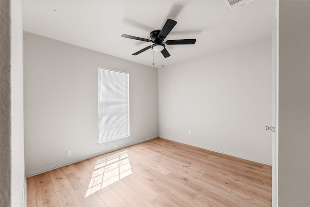 empty room with plenty of natural light, ceiling fan, and light hardwood / wood-style floors