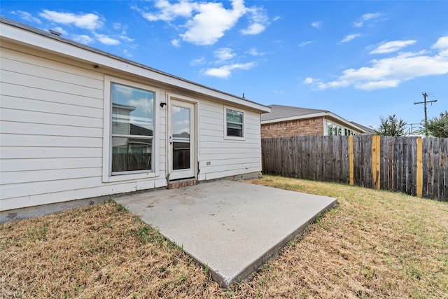 exterior space with a lawn and a patio