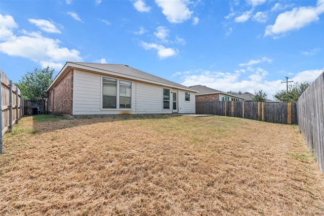 back of house with a lawn