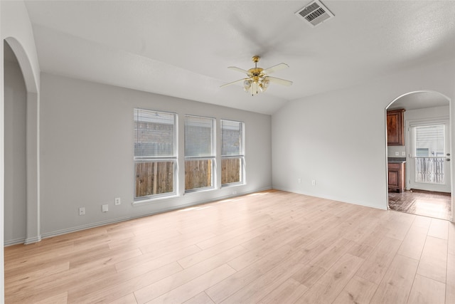 unfurnished room featuring lofted ceiling, light hardwood / wood-style flooring, and ceiling fan