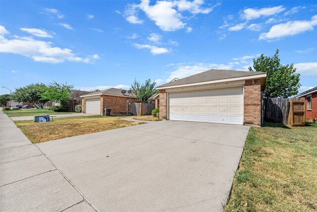 ranch-style home with a garage and a front yard