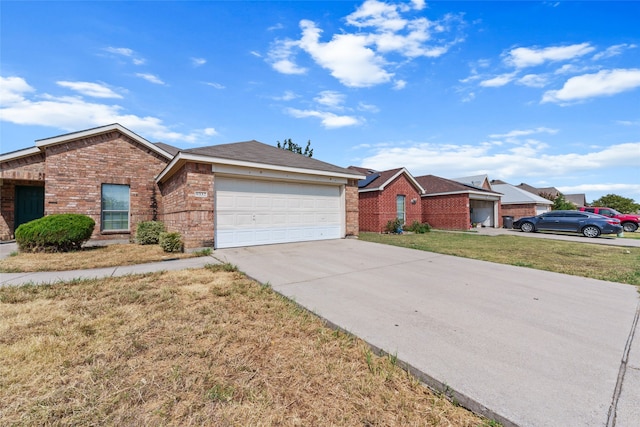 single story home featuring a garage and a front lawn