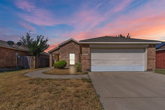 single story home with a yard and a garage