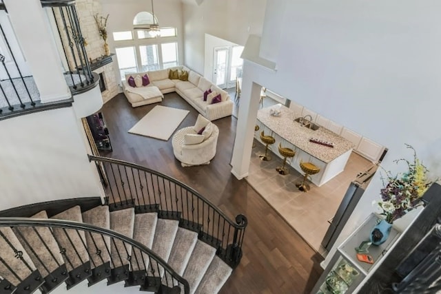 stairway with a high ceiling and wood-type flooring