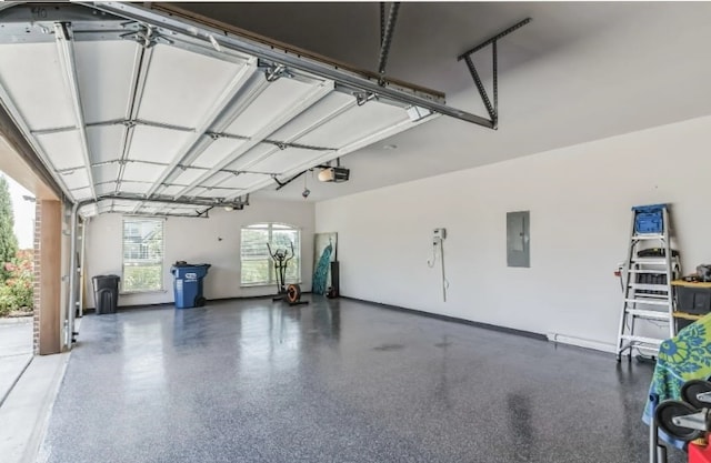 garage with electric panel and a garage door opener